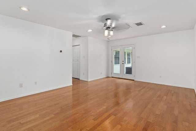 spare room featuring french doors, light wood-type flooring, and ceiling fan