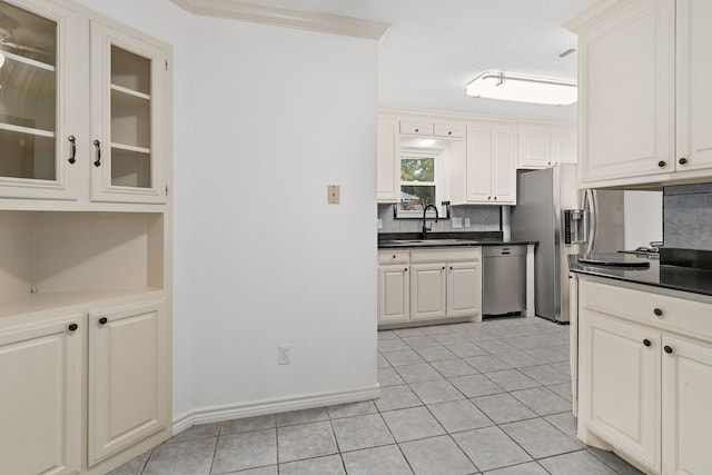 kitchen with white cabinets, light tile patterned floors, and appliances with stainless steel finishes