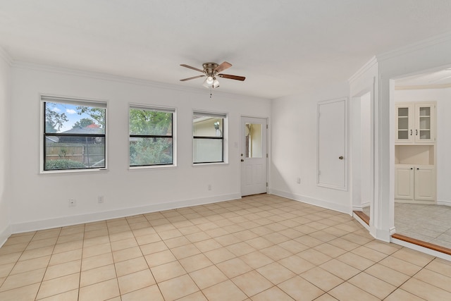 tiled spare room with ceiling fan and ornamental molding