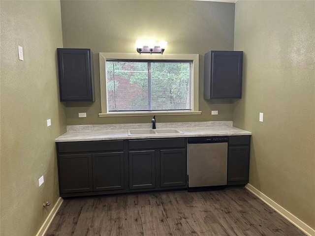 kitchen featuring dark hardwood / wood-style flooring, dishwasher, sink, and gray cabinetry