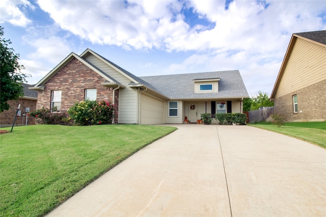 view of front of property featuring a garage and a front lawn