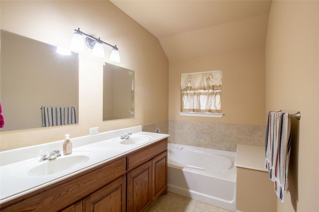 bathroom with a tub, tile patterned flooring, vanity, and vaulted ceiling