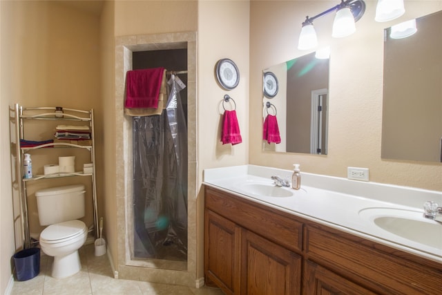 bathroom featuring toilet, vanity, tile patterned floors, and walk in shower