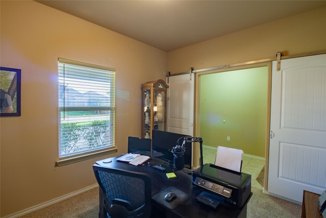 carpeted office with a barn door