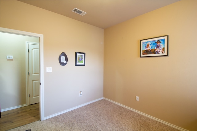 spare room featuring light carpet