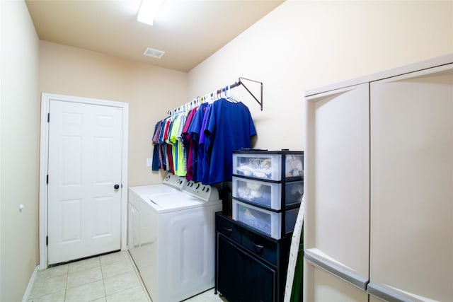 laundry room featuring independent washer and dryer and light tile patterned flooring