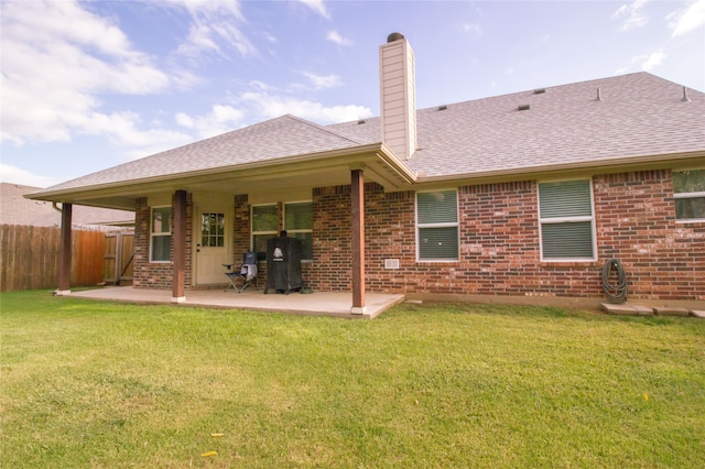 back of house featuring a patio area and a yard