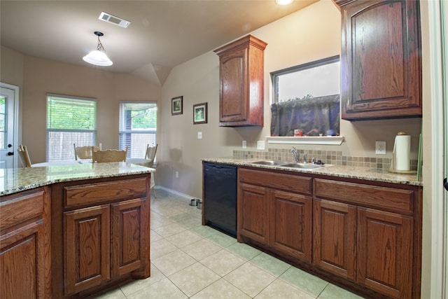 kitchen featuring light stone counters, sink, black dishwasher, hanging light fixtures, and light tile patterned flooring