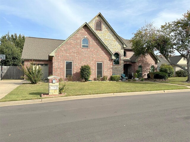 view of front of property with a garage and a front lawn