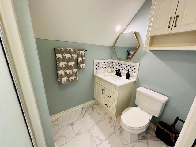 bathroom with tasteful backsplash, vanity, and toilet