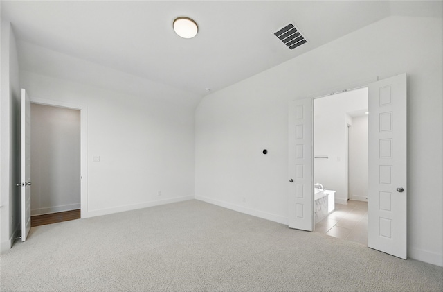 2131 Charming Forge Rd, Forney, TX 75126 - unfurnished bedroom with light colored carpet, lofted ceiling, and baseboards