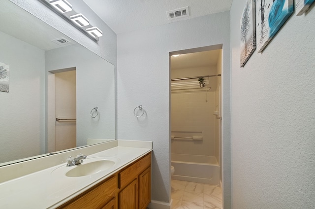 full bathroom with shower / bathing tub combination, vanity, a textured ceiling, and toilet