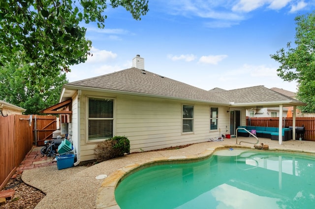 back of property featuring a fenced in pool, outdoor lounge area, and a patio area