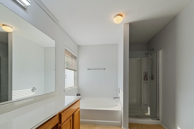 bathroom with vanity and separate shower and tub