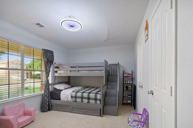 bedroom featuring carpet flooring and a textured ceiling