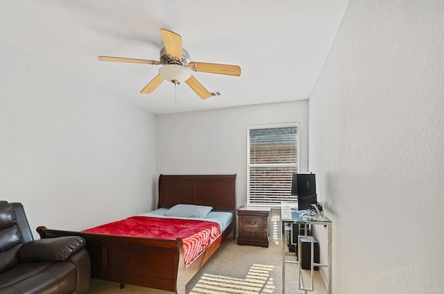 bedroom featuring ceiling fan and light carpet