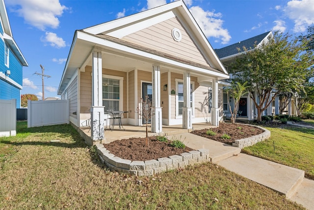 view of front of home featuring covered porch, central air condition unit, and a front yard