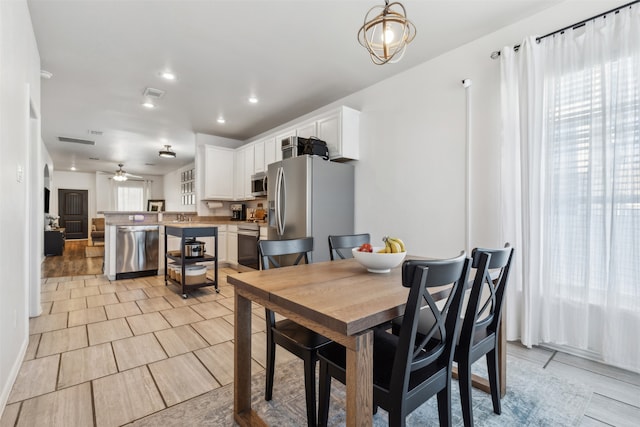 dining space featuring ceiling fan and light hardwood / wood-style floors