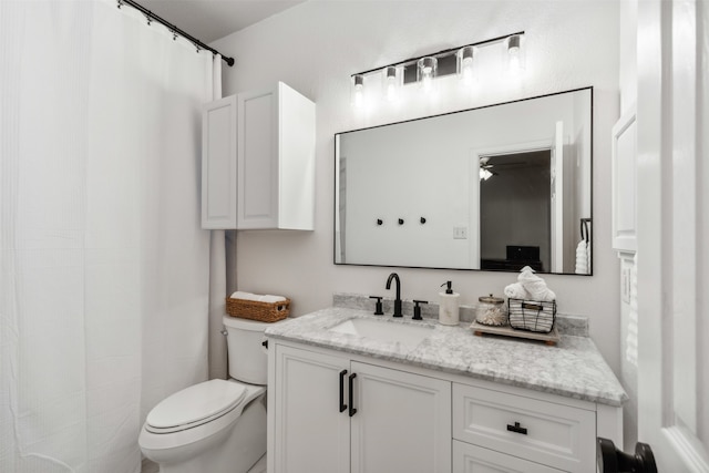 bathroom with vanity, ceiling fan, and toilet