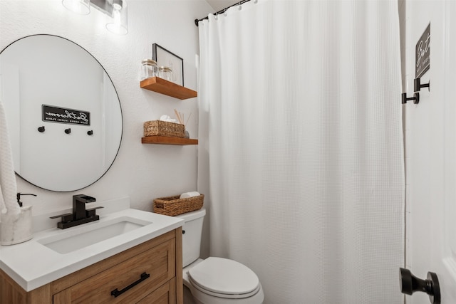 bathroom featuring vanity and toilet