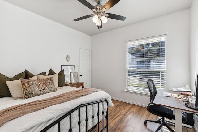 bedroom featuring dark hardwood / wood-style flooring and ceiling fan