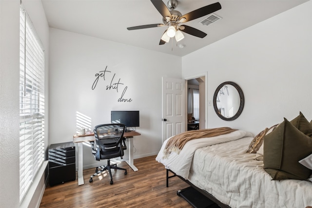 bedroom with ceiling fan and dark wood-type flooring