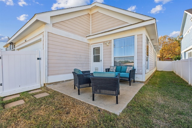 back of property featuring outdoor lounge area, a patio area, and a lawn