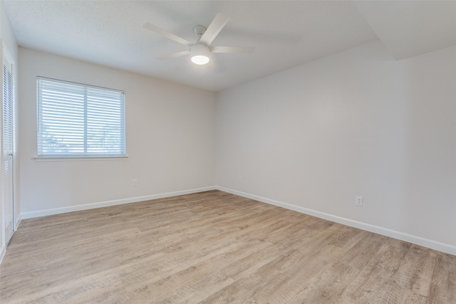 unfurnished room with ceiling fan and light hardwood / wood-style flooring