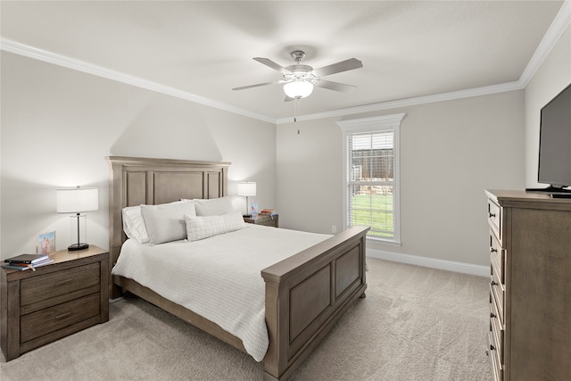 carpeted bedroom featuring ceiling fan and crown molding