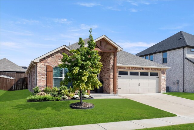 view of front of home with a garage and a front lawn