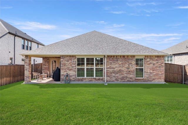 rear view of house featuring a lawn and a patio area