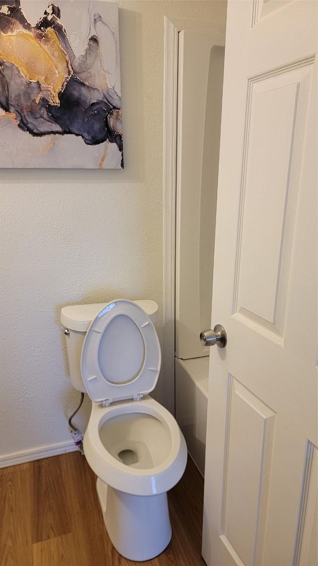 2001 Alma, Sherman, TX 75090 - bathroom with toilet, wood finished floors, and baseboards