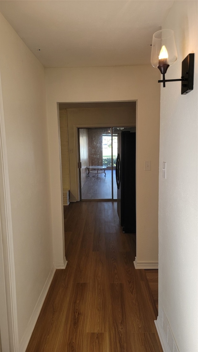 corridor with dark hardwood / wood-style floors