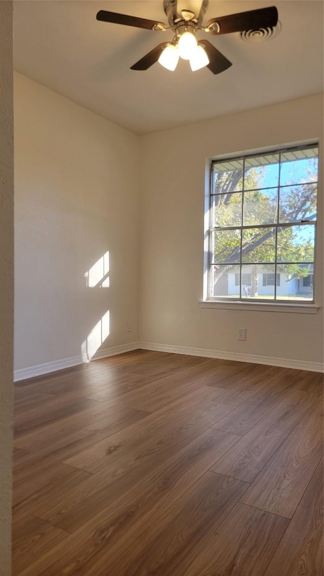 2001 Alma, Sherman, TX 75090 - unfurnished room with dark wood finished floors, baseboards, and a ceiling fan