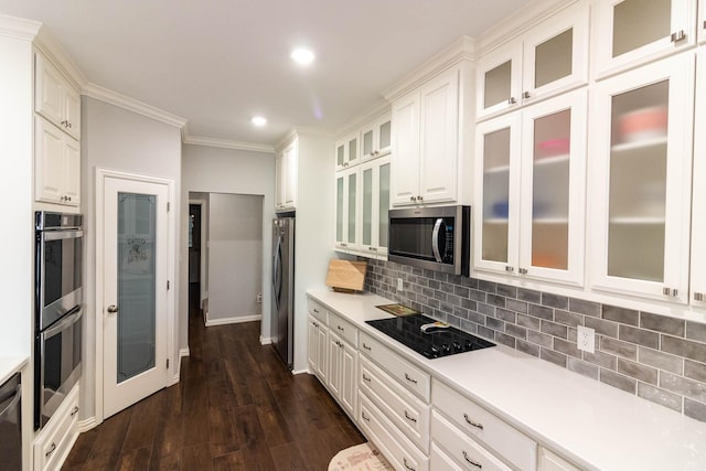 kitchen featuring white cabinets, black appliances, glass insert cabinets, and light countertops