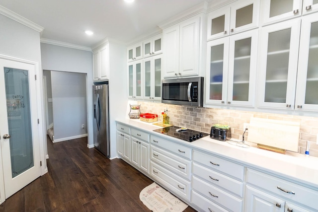 kitchen featuring white cabinets, glass insert cabinets, stainless steel appliances, and light countertops