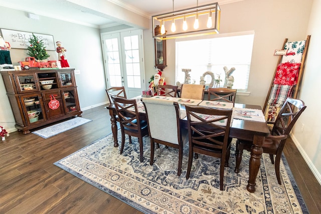 dining space with dark hardwood / wood-style flooring, french doors, and ornamental molding