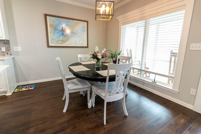 dining area featuring dark wood-style floors, baseboards, and ornamental molding