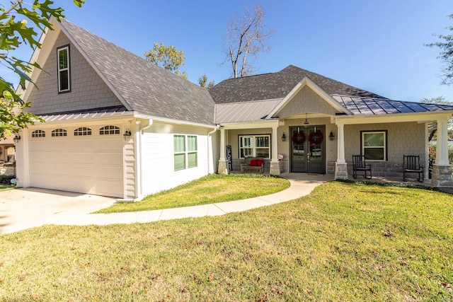 view of front of property featuring metal roof, covered porch, french doors, a standing seam roof, and a front yard