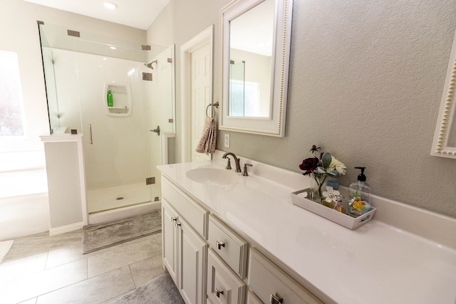 bathroom featuring tile patterned floors, vanity, and walk in shower