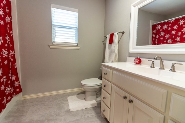 bathroom with tile patterned floors, vanity, and toilet