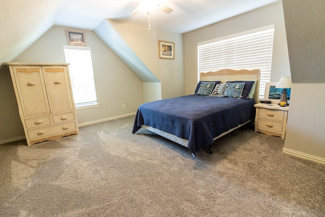 carpeted bedroom featuring ceiling fan and vaulted ceiling