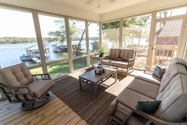 sunroom / solarium featuring a water view and a healthy amount of sunlight