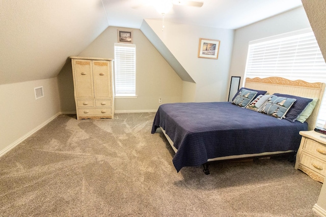 bedroom with baseboards, visible vents, vaulted ceiling, and light colored carpet