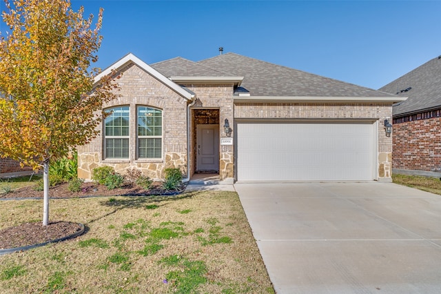 ranch-style house with a garage and a front lawn