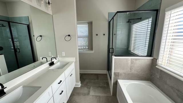 bathroom featuring vanity, plenty of natural light, and independent shower and bath