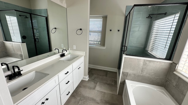 bathroom with plenty of natural light, separate shower and tub, and vanity