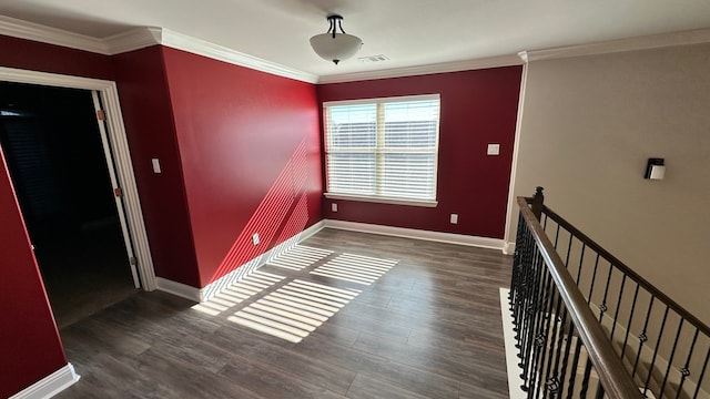 empty room with dark hardwood / wood-style floors and ornamental molding