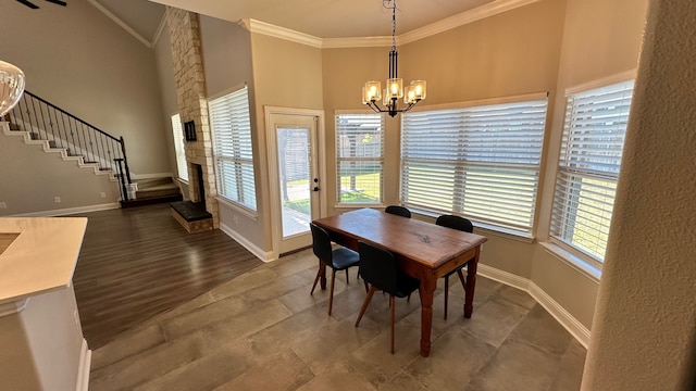 dining room with a chandelier, wood-type flooring, ornamental molding, and a high ceiling