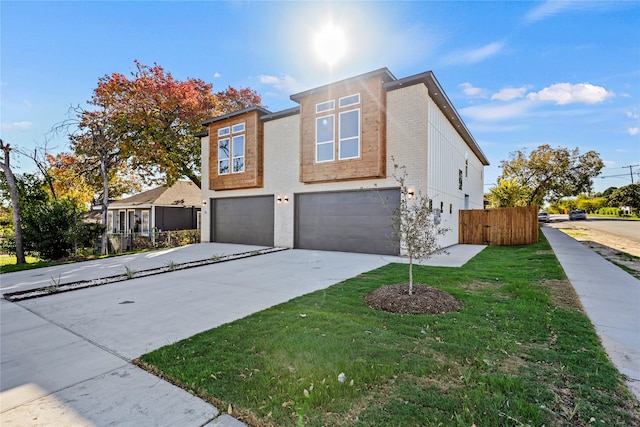 view of front of house with a garage and a front yard